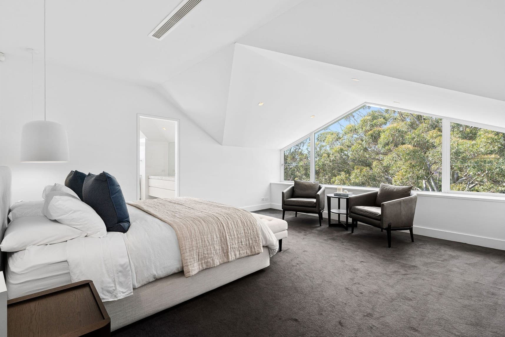 A light-filled attic conversion with a raked ceiling and panoramic window.